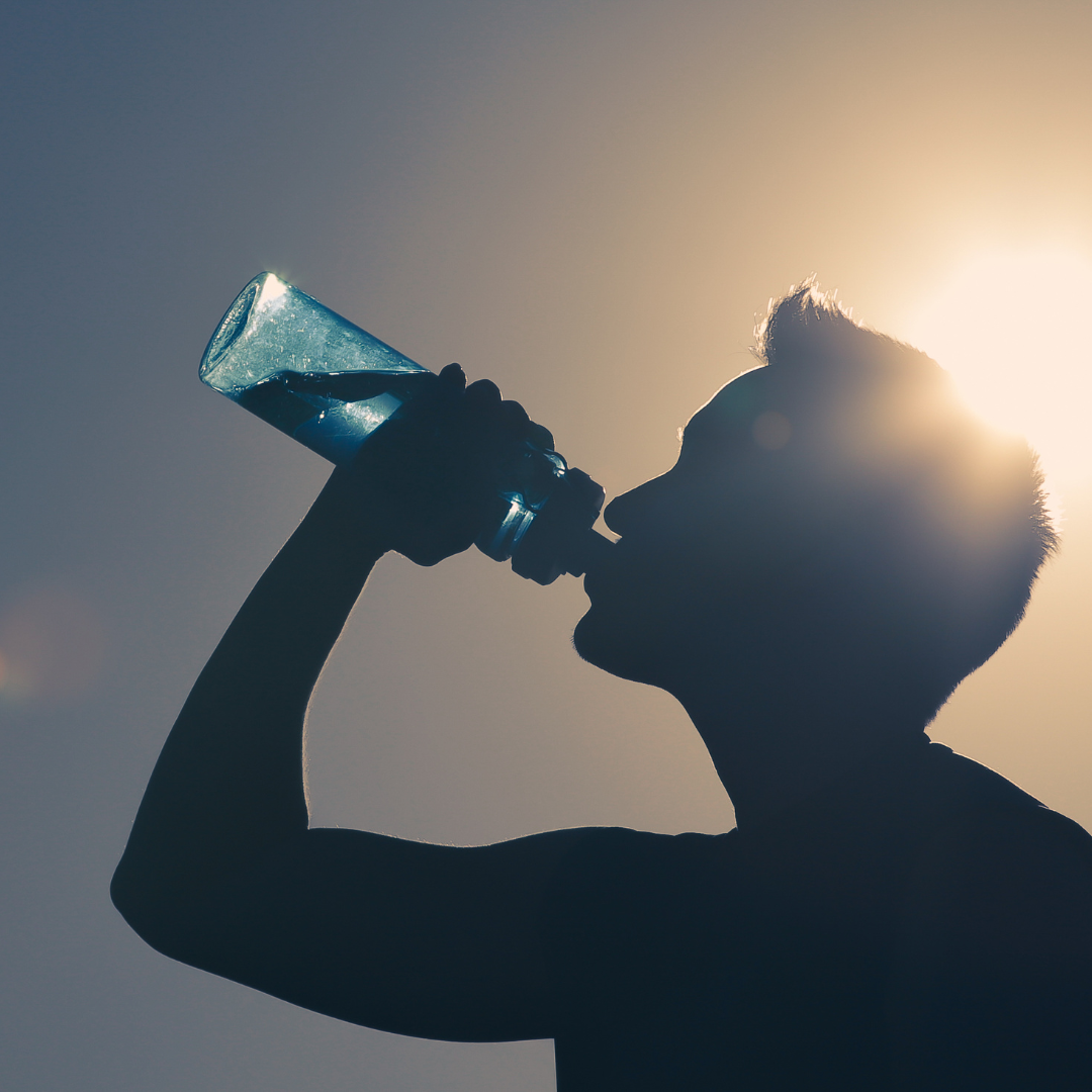 Man drinking water in the hot weather