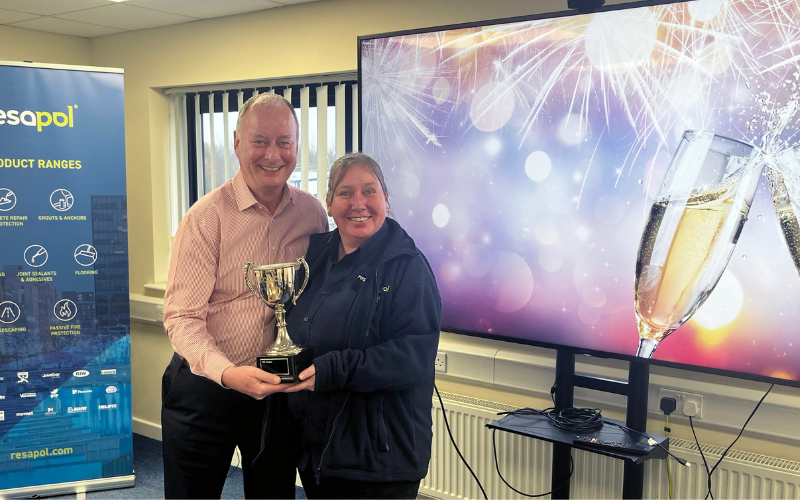 Managing Director Lloyd Phillips presents Stockton Branch Manager, Samantha Oliver, with the trophy